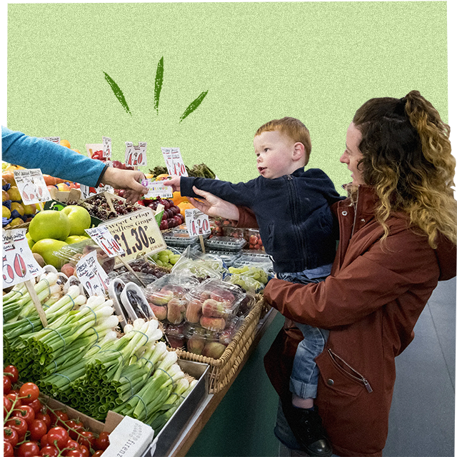 child and mother buying fruit and veg